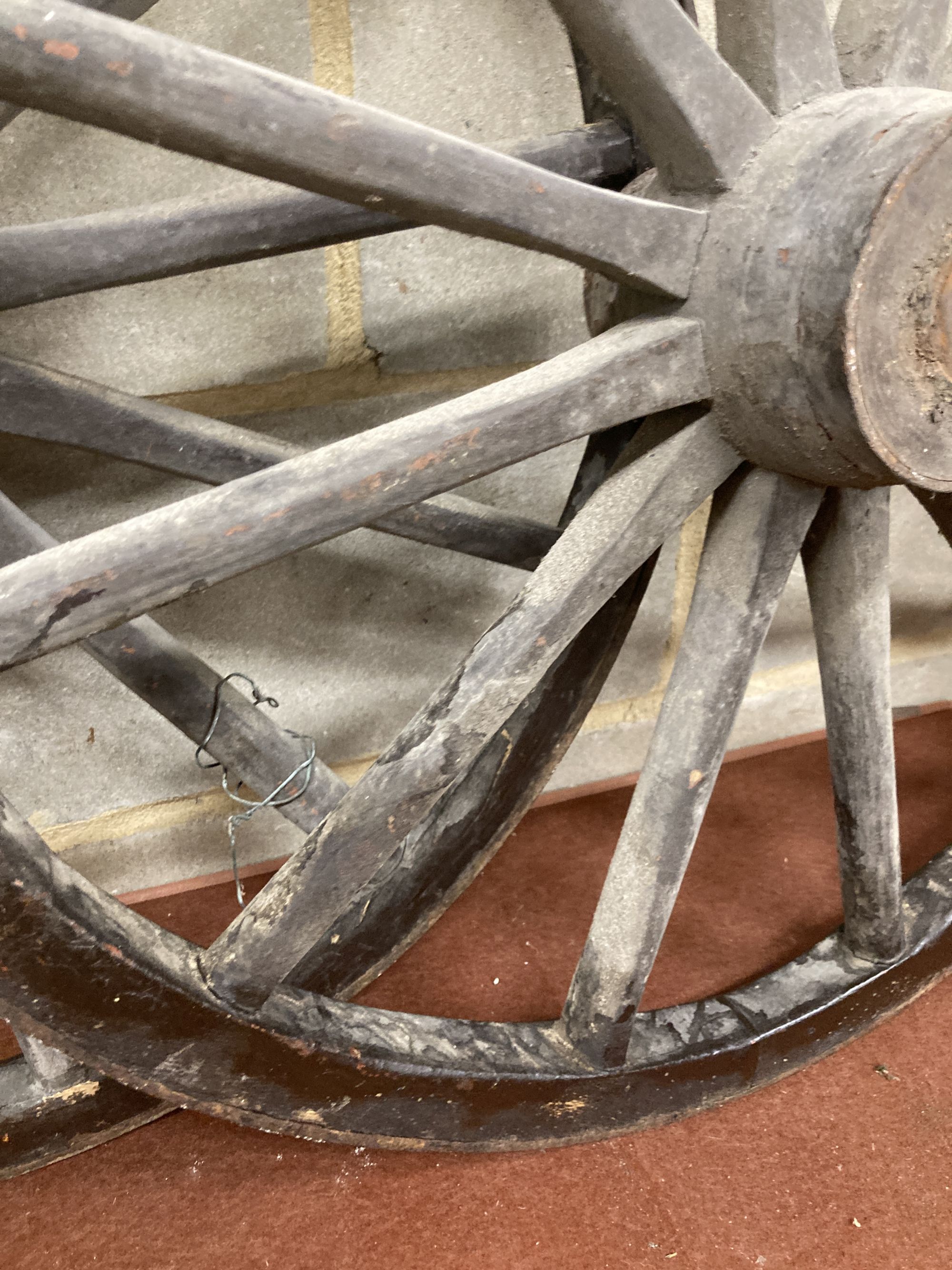 A pair of Victorian iron mounted spoked cart wheels, 70cm diameter